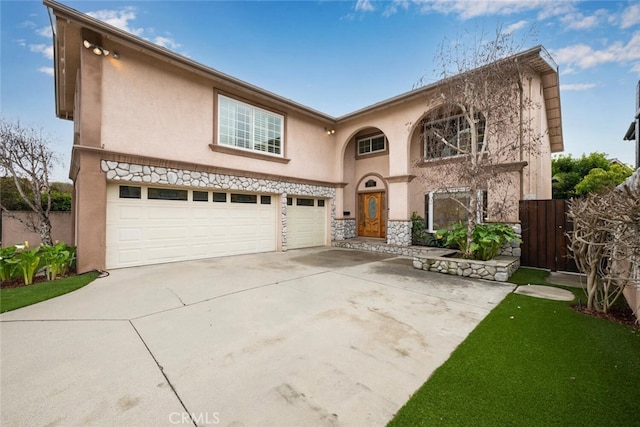 view of front of home featuring stucco siding, concrete driveway, a garage, and fence