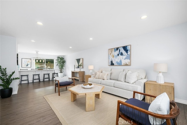 living area featuring recessed lighting, baseboards, and wood finished floors