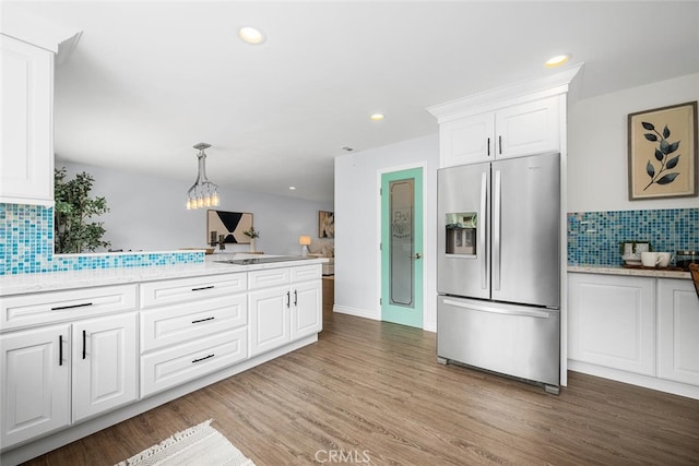 kitchen featuring tasteful backsplash, recessed lighting, stainless steel fridge, white cabinets, and light wood finished floors