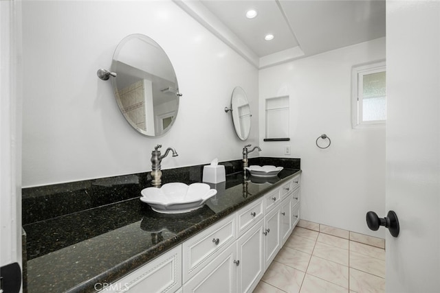 bathroom with double vanity, recessed lighting, tile patterned floors, and a sink