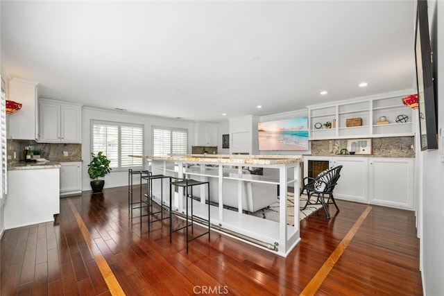 kitchen with dark wood finished floors, decorative backsplash, white cabinetry, and open shelves