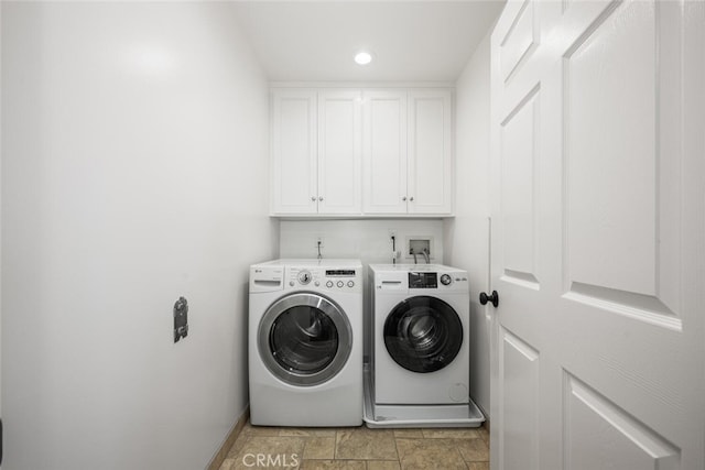 laundry room with washer and dryer, recessed lighting, cabinet space, and stone finish flooring