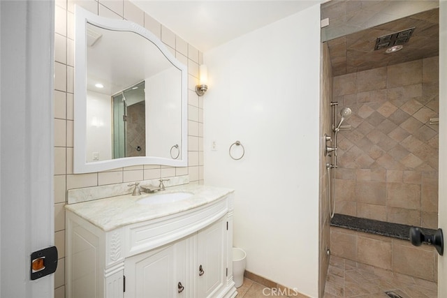 bathroom with vanity, tile patterned floors, and a stall shower