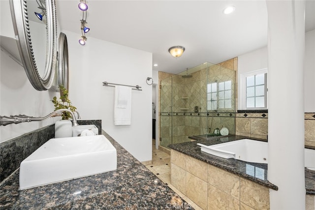 bathroom with vanity, recessed lighting, a tub with jets, and tiled shower