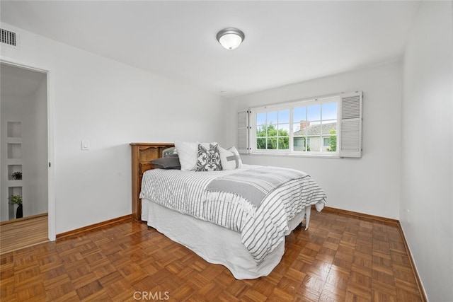 bedroom with visible vents and baseboards