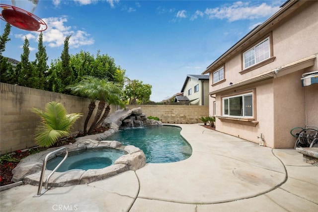 view of swimming pool with a patio, a fenced backyard, and a pool with connected hot tub