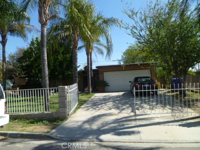 exterior space with a garage, fence, and concrete driveway