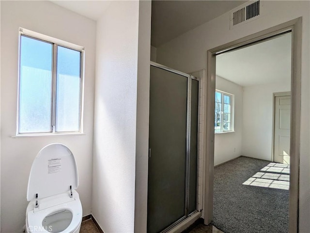 bathroom with visible vents and a shower stall