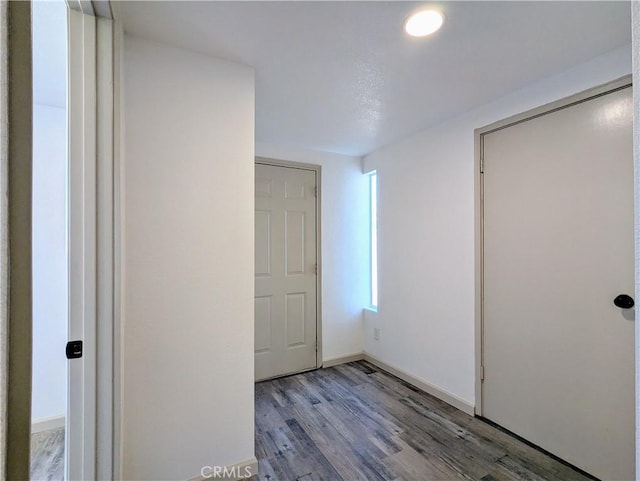 unfurnished bedroom with baseboards and wood finished floors