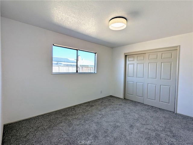 unfurnished bedroom with a closet, carpet flooring, and a textured ceiling