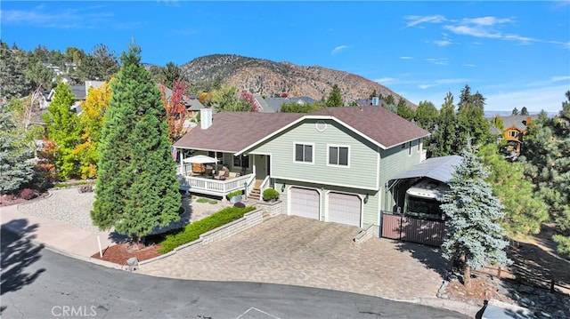 view of front of home with a garage, decorative driveway, and a mountain view