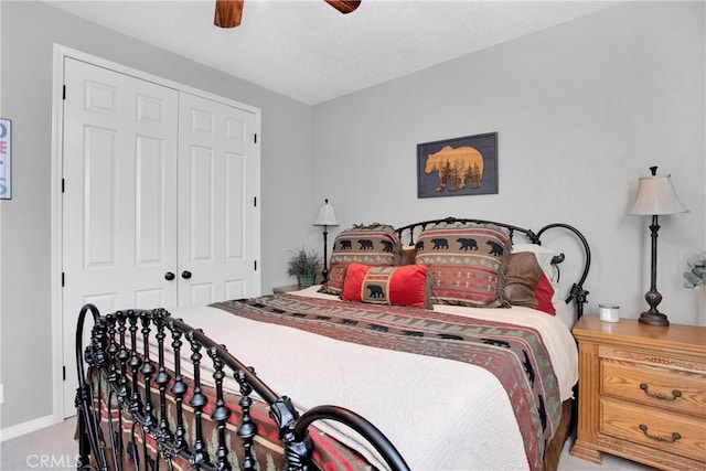 carpeted bedroom featuring a closet, baseboards, and a ceiling fan