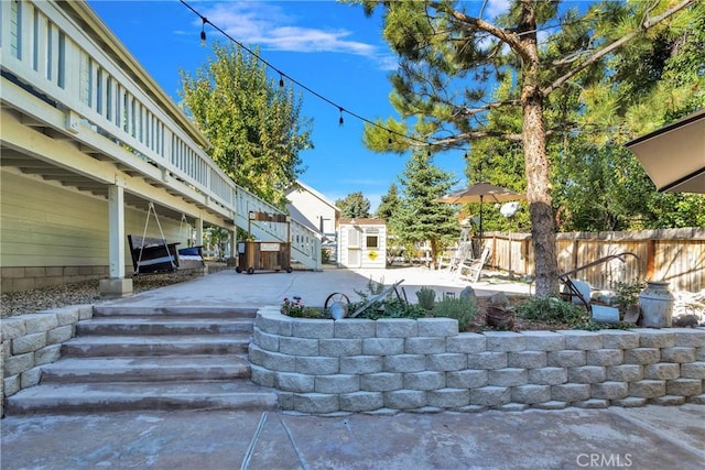 view of yard with stairs, a patio, and fence