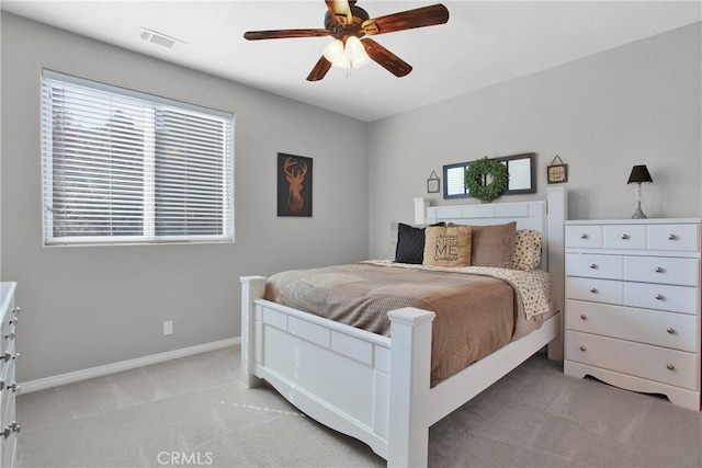 bedroom featuring ceiling fan, light colored carpet, visible vents, and baseboards