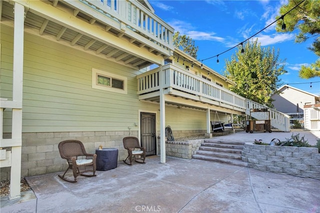 view of patio with stairway and a deck