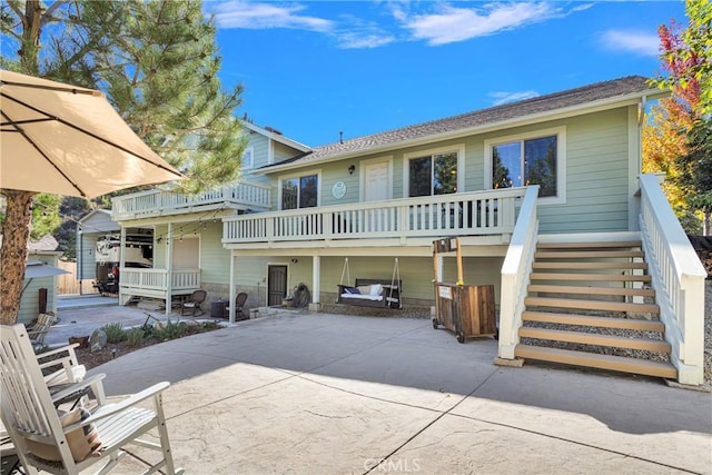 back of house with stairway and a patio