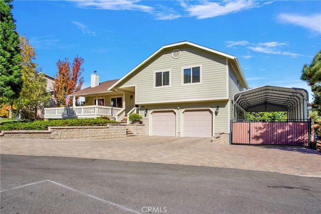 tri-level home with a chimney, decorative driveway, and a garage
