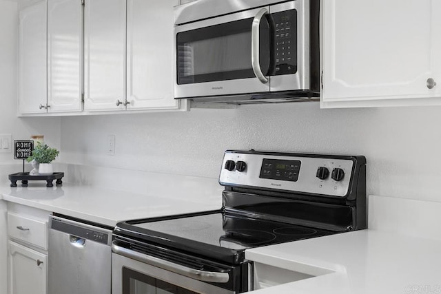 kitchen featuring white cabinets, stainless steel appliances, and light countertops