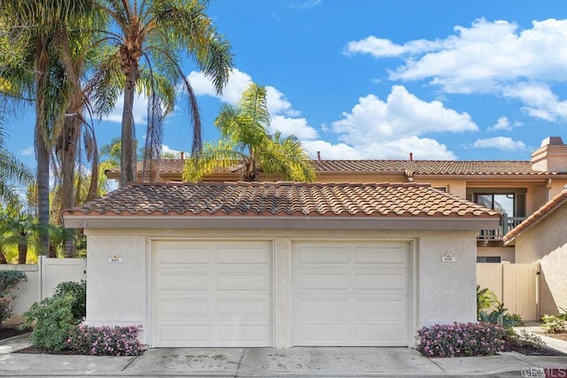 detached garage featuring fence