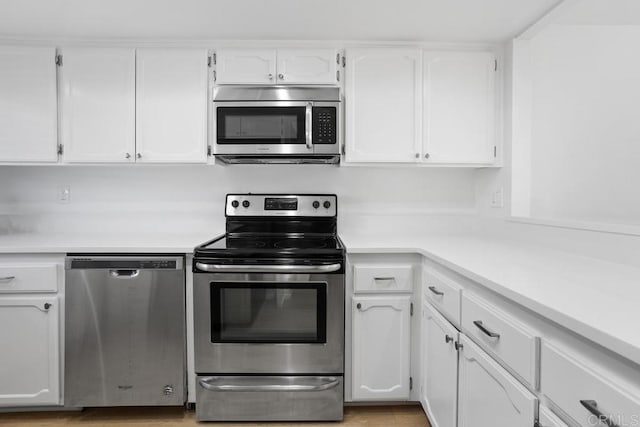 kitchen featuring white cabinetry, appliances with stainless steel finishes, and light countertops