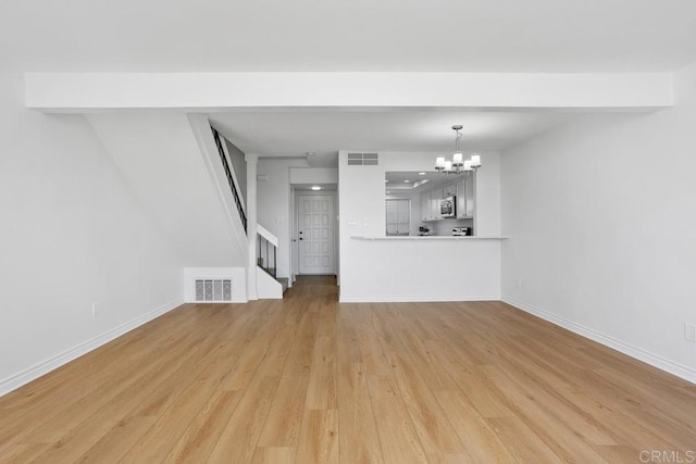 unfurnished living room with baseboards, visible vents, an inviting chandelier, stairs, and light wood-type flooring