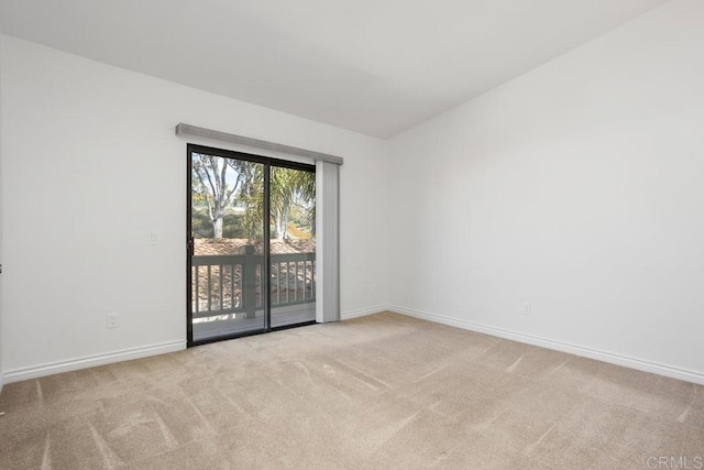 carpeted spare room with baseboards