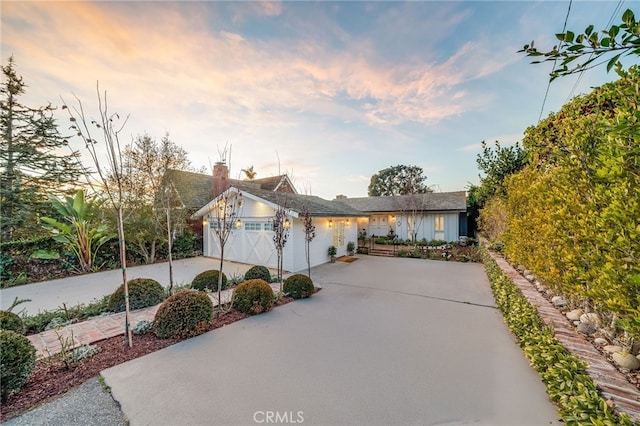 view of front of property with a garage and concrete driveway