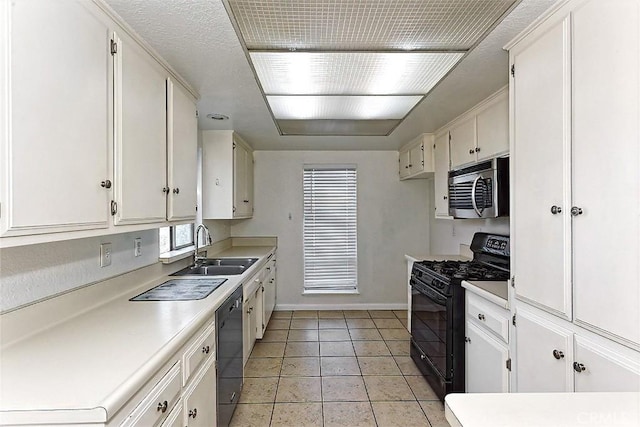 kitchen with light tile patterned flooring, a sink, black appliances, light countertops, and white cabinetry