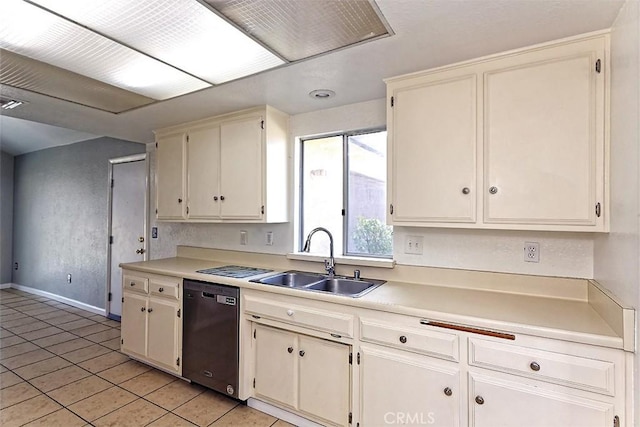 kitchen featuring light tile patterned flooring, dishwashing machine, light countertops, and a sink