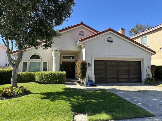 mediterranean / spanish house with stucco siding, an attached garage, driveway, and a front yard