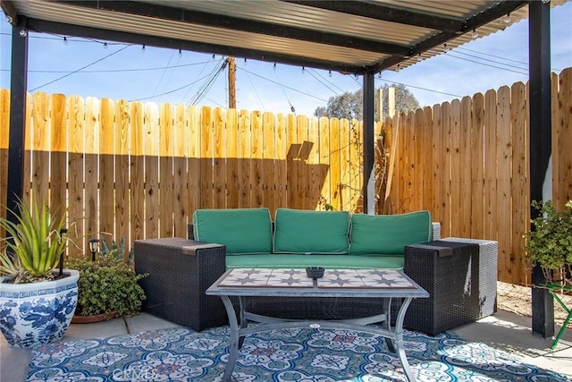 view of patio featuring outdoor lounge area and fence