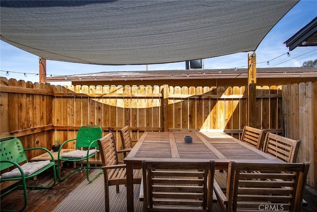 deck featuring fence and outdoor dining space