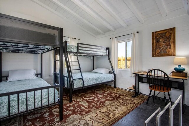 bedroom with vaulted ceiling with beams and wood ceiling