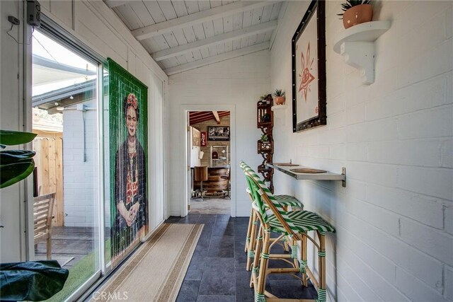 hallway featuring wood ceiling and vaulted ceiling with beams