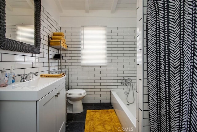 bathroom featuring tile patterned floors, tile walls, toilet, and a bath