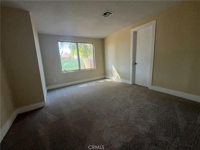 spare room featuring visible vents, baseboards, and carpet floors