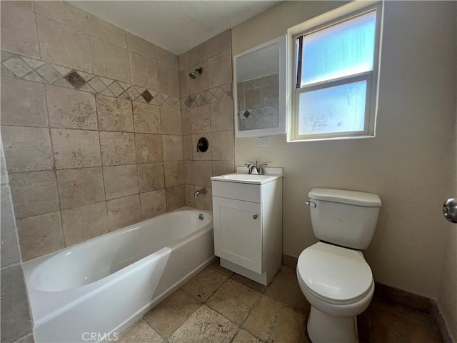 bathroom with toilet, vanity, baseboards, and bathtub / shower combination