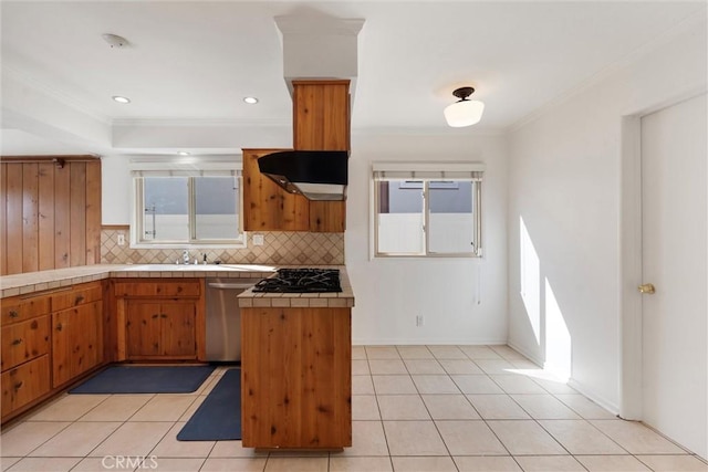 kitchen with light tile patterned floors, tile counters, dishwasher, brown cabinets, and backsplash