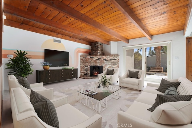 living room featuring carpet floors, beam ceiling, visible vents, a brick fireplace, and wood ceiling