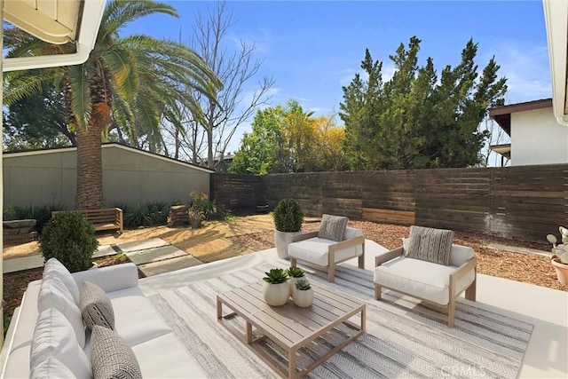 wooden deck with a fenced backyard, a patio, and an outdoor hangout area