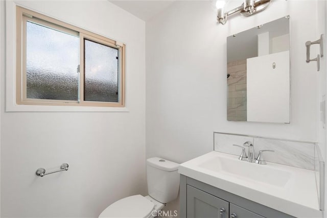 bathroom with toilet and vanity