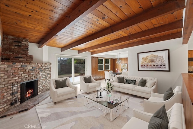 living area with a brick fireplace, wood ceiling, beamed ceiling, and wood finished floors