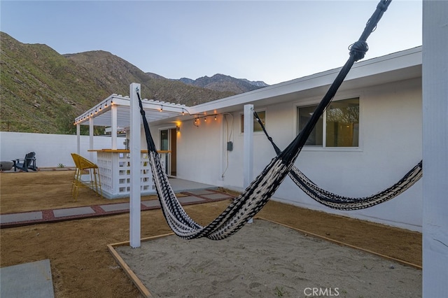 22470 Fawnridge Dr, Palm Springs, CA 92262 - view of property exterior featuring a patio area, fence, a mountain view, and stucco siding