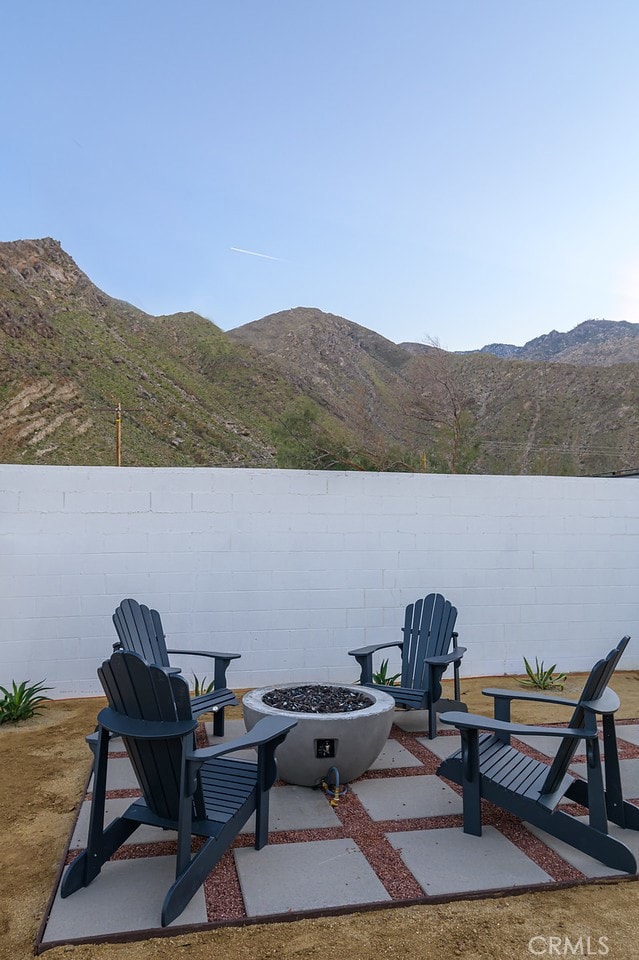 22470 Fawnridge Dr, Palm Springs, CA 92262 - view of patio / terrace with fence, a fire pit, and a mountain view