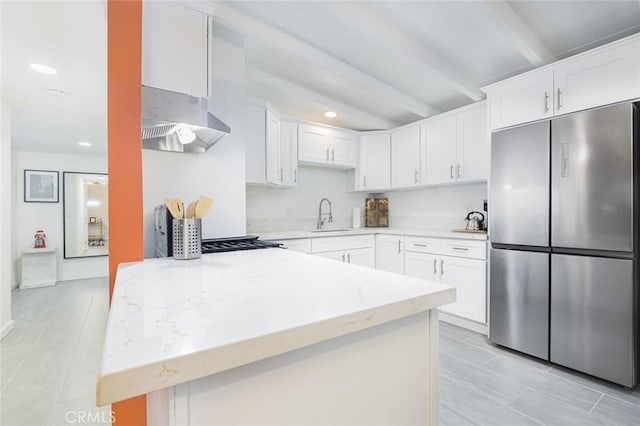 22470 Fawnridge Dr, Palm Springs, CA 92262 - kitchen with light stone counters, a sink, ventilation hood, stainless steel fridge, and beamed ceiling