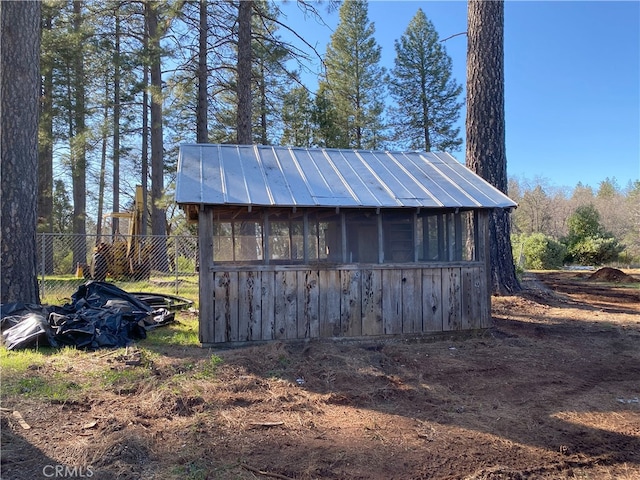 view of outbuilding featuring an outbuilding and fence