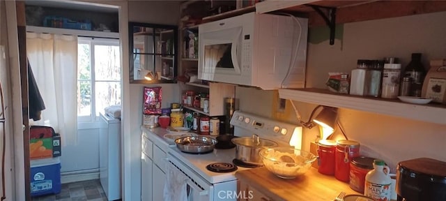 kitchen with white appliances, washer / dryer, and light countertops