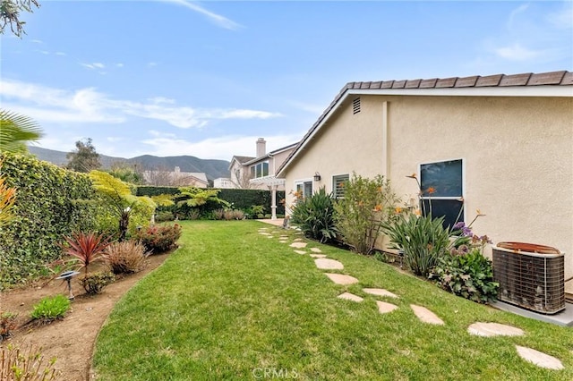 view of yard featuring cooling unit and a mountain view