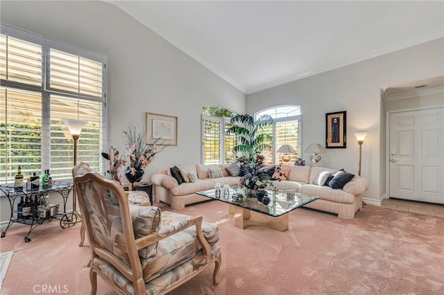 carpeted living room with high vaulted ceiling, baseboards, and ornamental molding