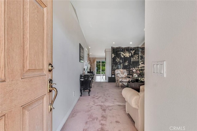 entrance foyer with baseboards and light carpet